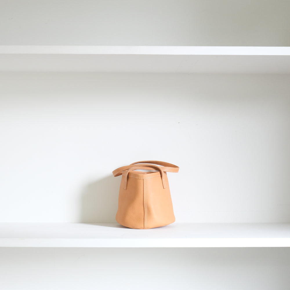 Leather round mini bag: long handles